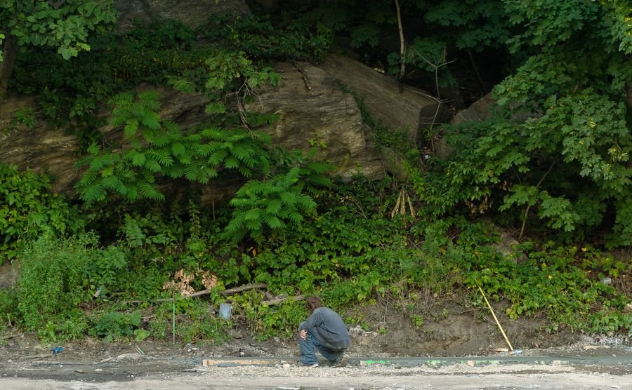 man writing in wet concrete