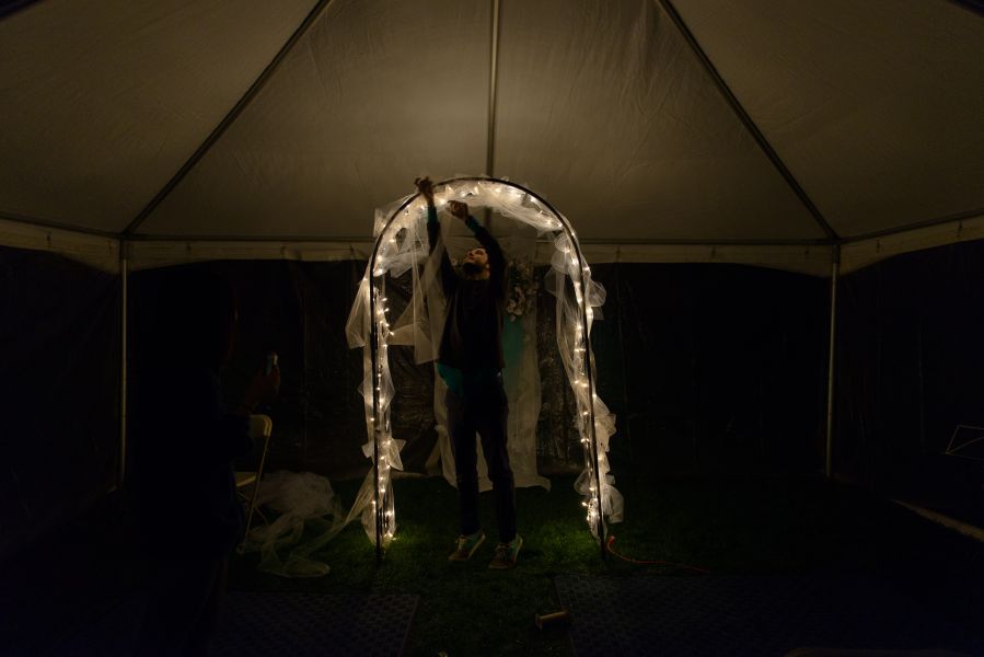 man decorating wedding archway