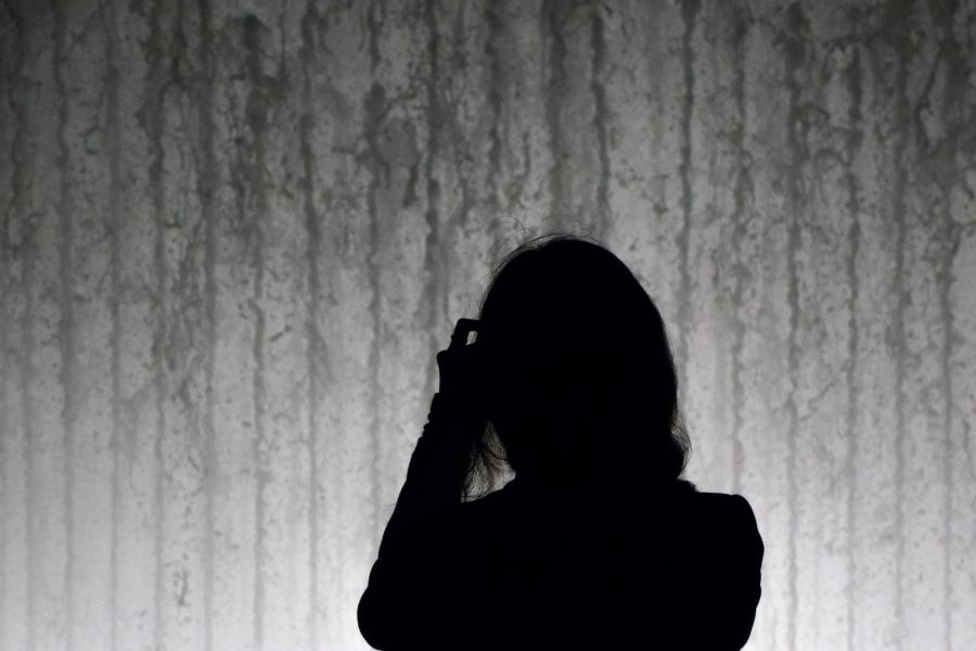 Woman taking a photo of the fountain at Lincoln Center
