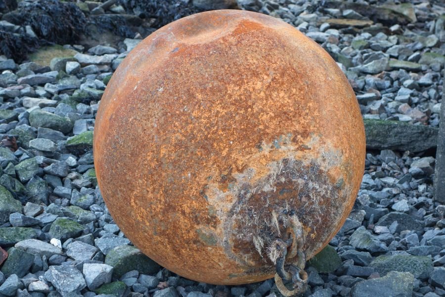 Rusty ball on the rocks
