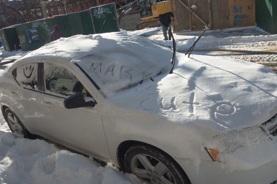 A message in the snow on a car