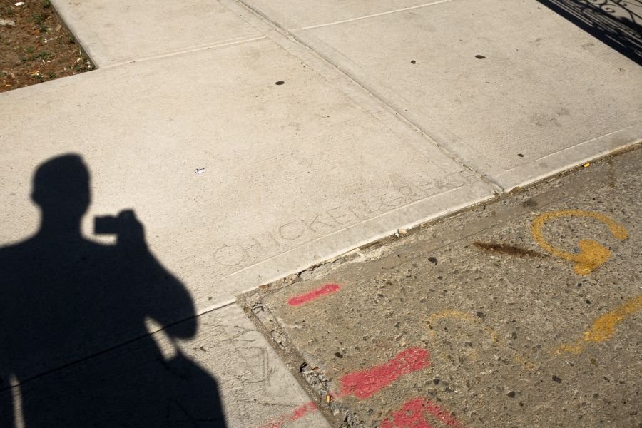 CHICKEN GREASE graffiti in sidewalk