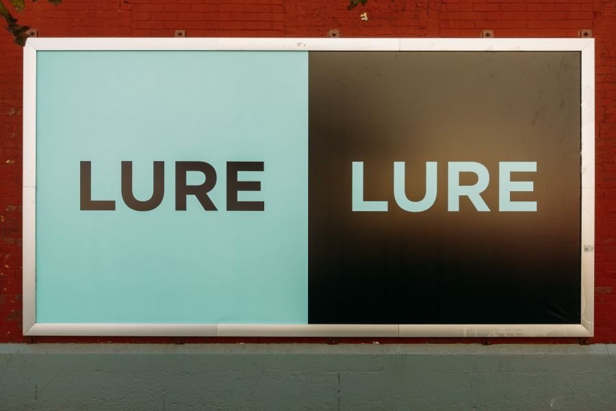 A street level "Lure" sign on a wall in Hudson Square